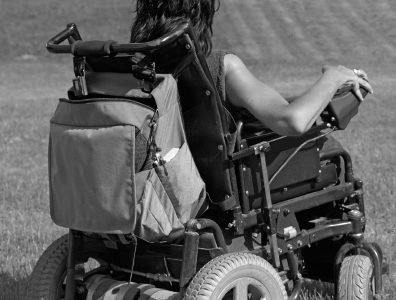 Greyscale photo of a woman in a wheelchair.