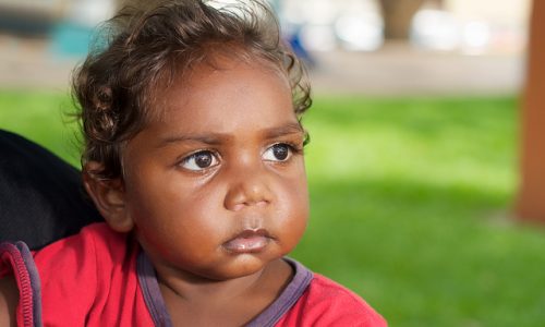 Aboriginal girl looking into the distance.