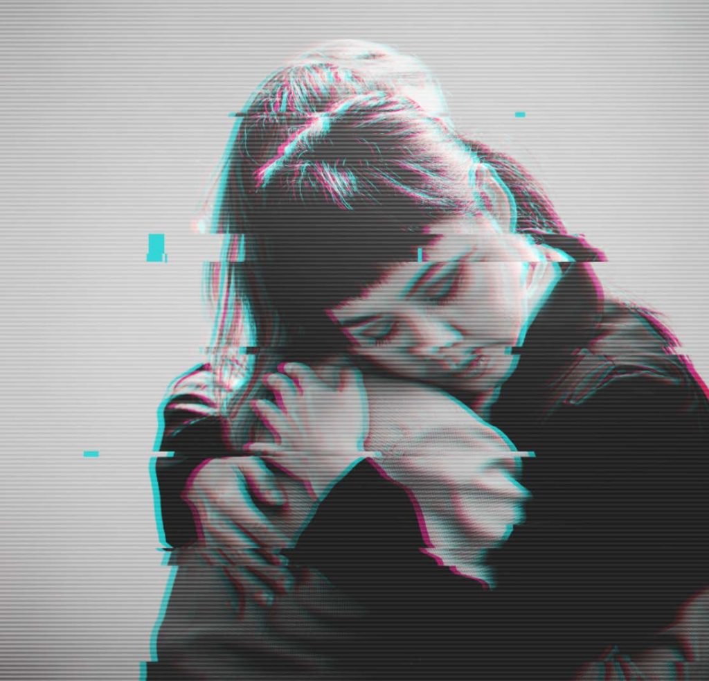 Greyscale image of two women hugging.