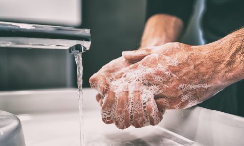Photo of a person washing their hands.