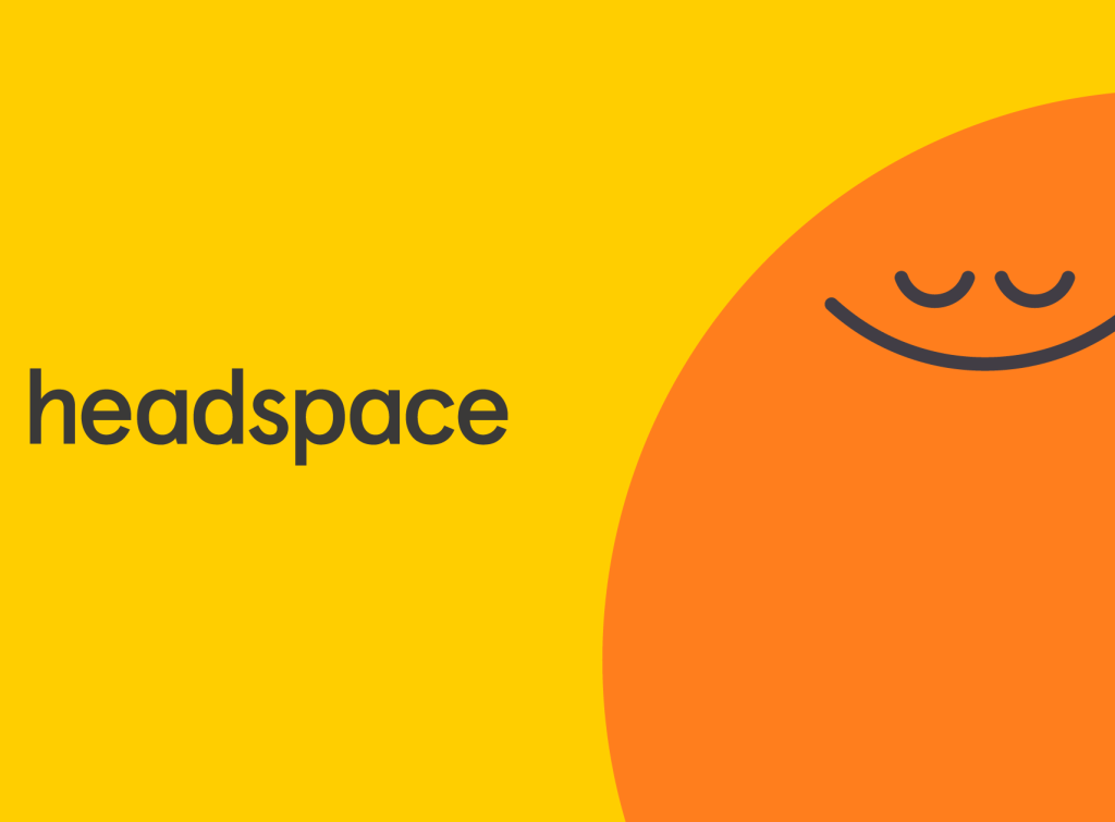 Bright yellow background a big orange emoji looking calm with the word headspace.