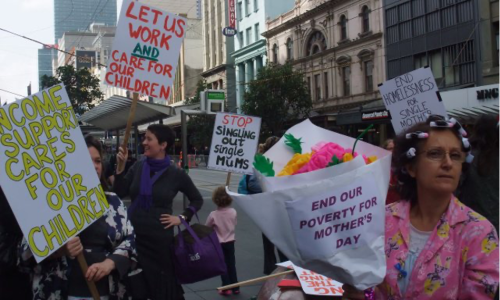 A photo of Helen (right) in 2010, protesting in a crowd with the Council of Single Mothers.