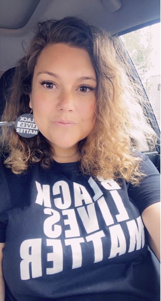 Photo of Tabitha Lean, a young Gunditjmara woman wearing earings and a black t-shirt that reads Black Lives Matter.