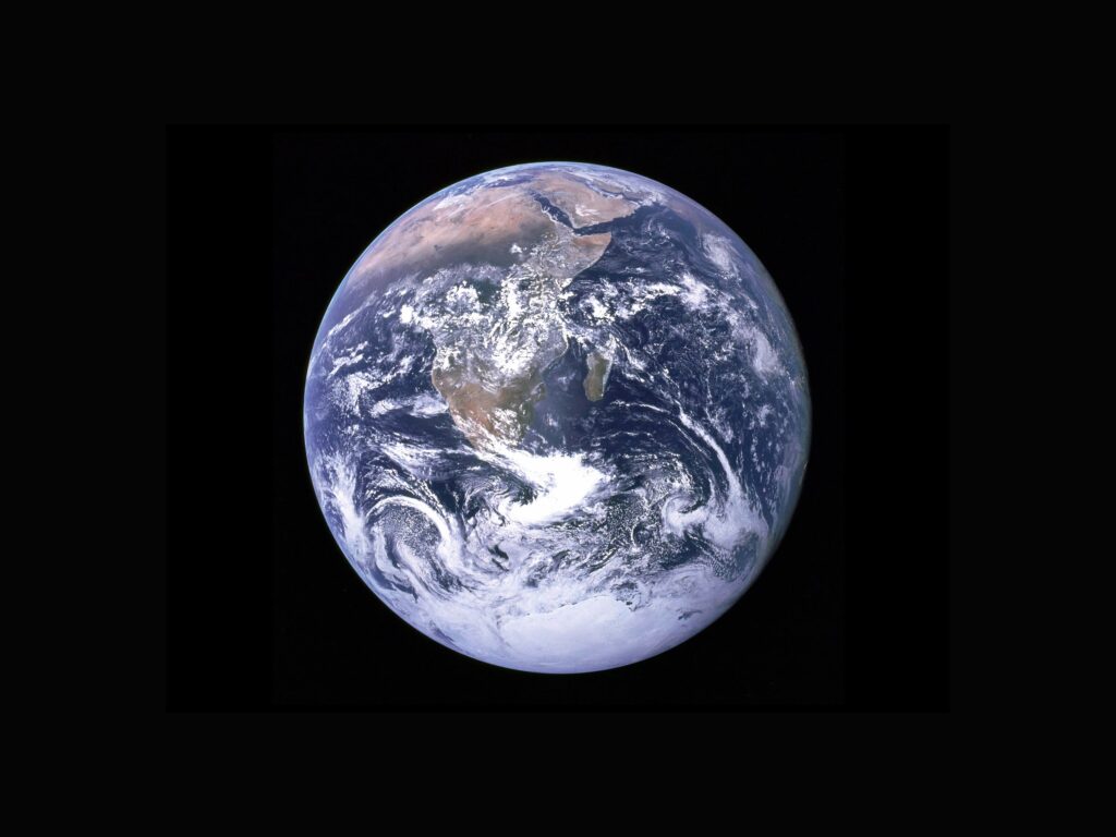 [Image: Black background with a stock image of the Earth in space taken by NASA.]